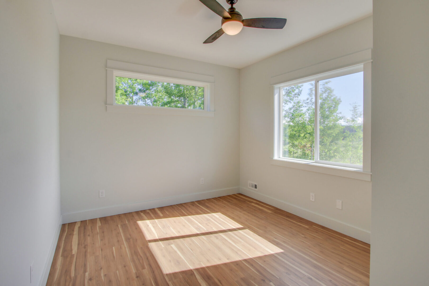 A small, empty room with white walls and a large window
