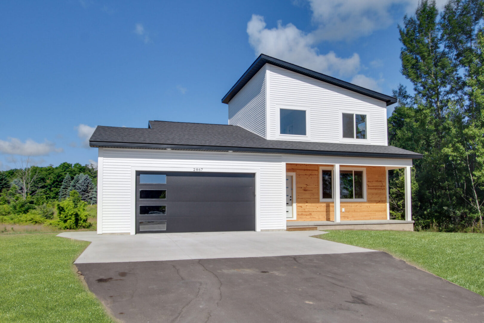 A two-story property with garage, white and wood exteriors